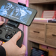 A photo of a person holding the SteelSeries Stratus+